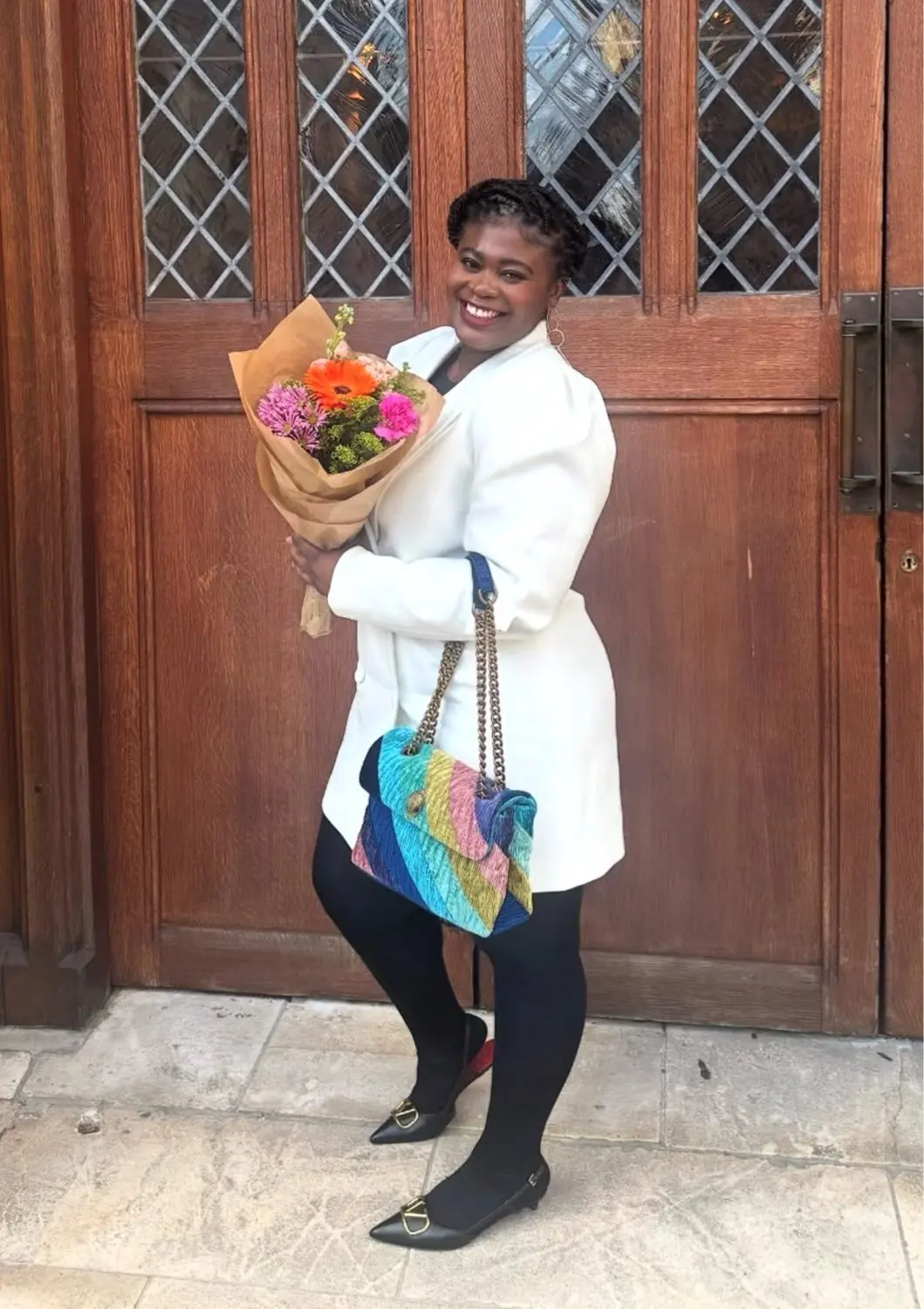 Sandra (Serwaa), Michael's cousin, smiling with a bouquet of flowers