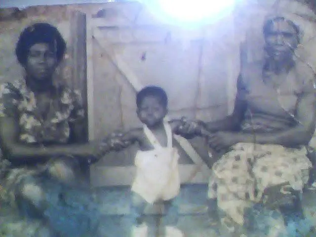 Kate (Serwaa), Michael's grandmother, seated on the right in a traditional Ghanaian setting