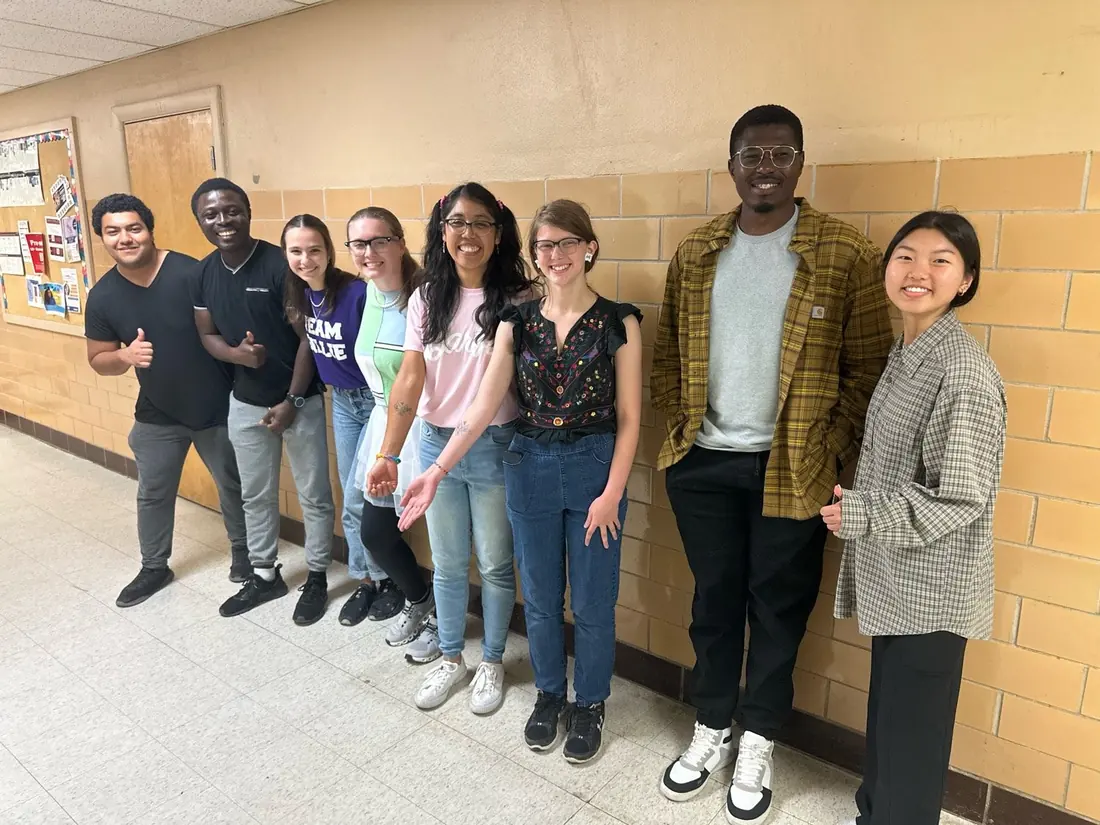 The Ramsey Lab dressed as each other for Halloween — graduate students and mentors lining a university hallway